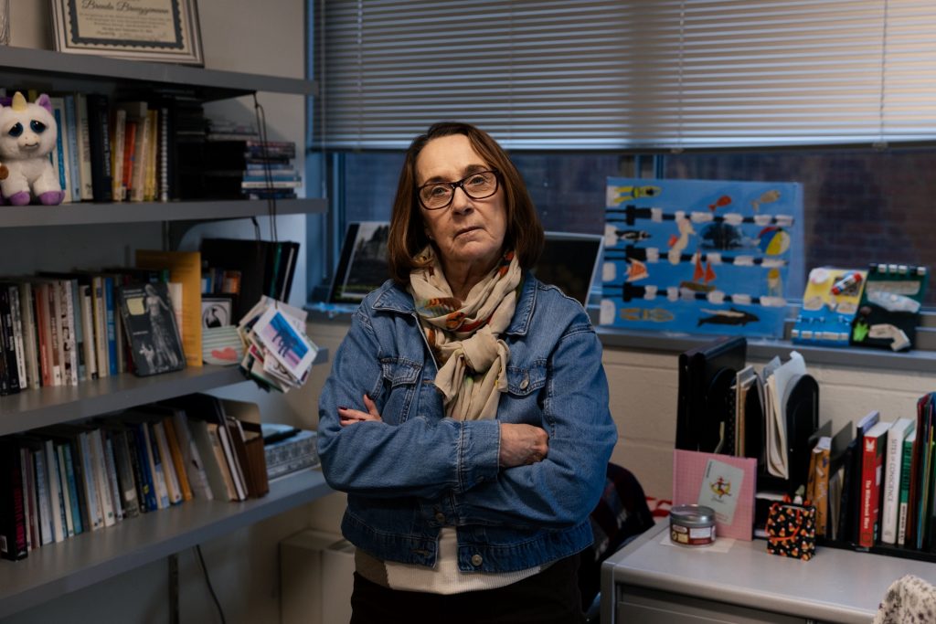 Brenda Brueggemann, professor at the University of Connecticut and director of the Mansfield Training School Memorial and Museum Project, poses in her office on campus. Photo by Shahrzad Rasekh for The Connecticut Mirror.